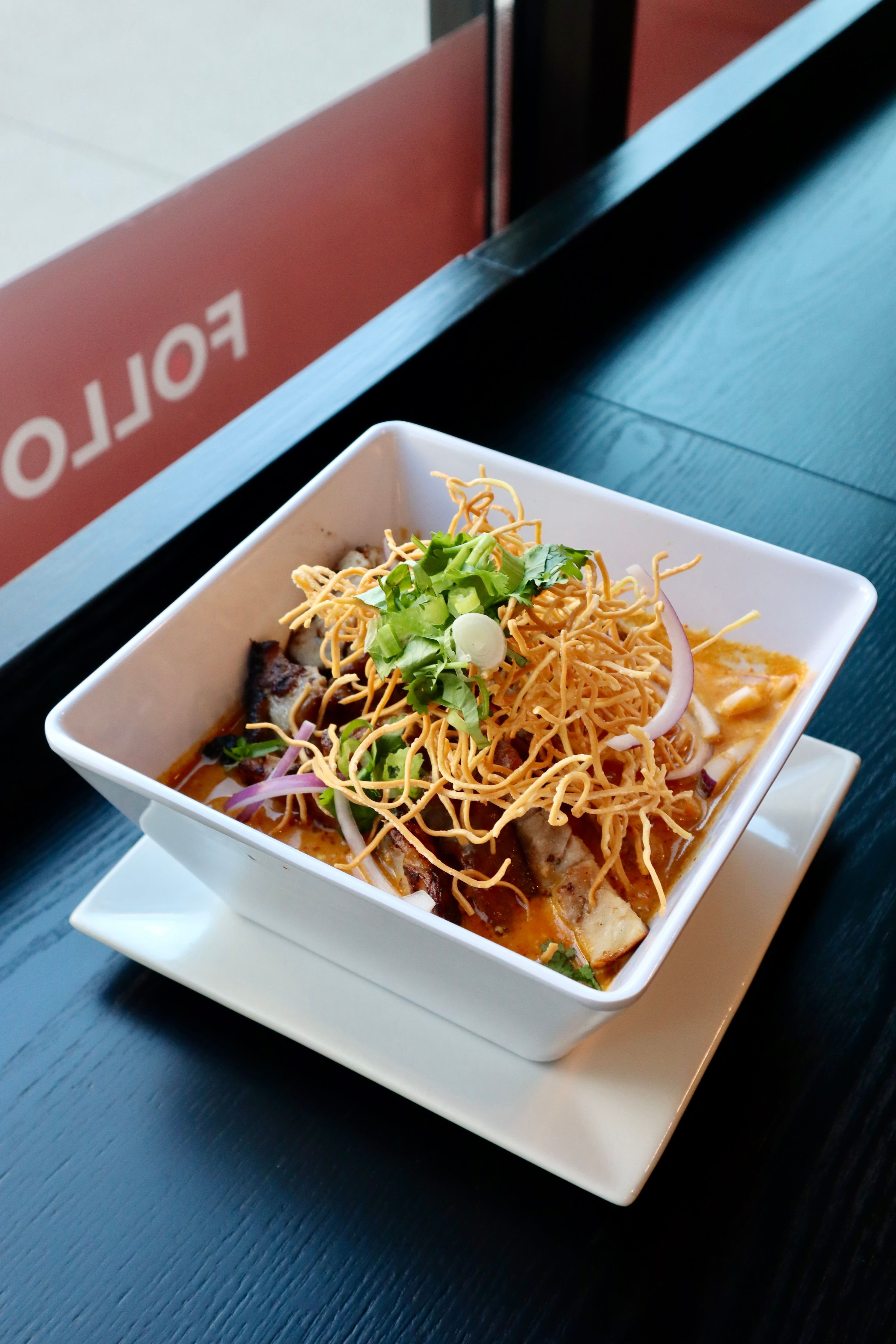 Khao Soi curry noodle soup topped with crispy noodles